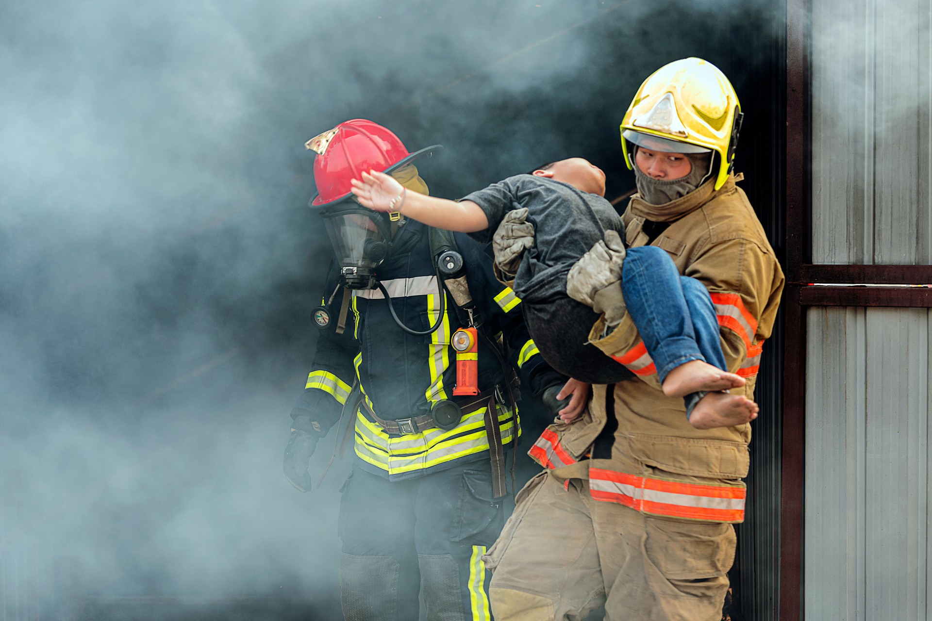 Firefighter carrying Boy