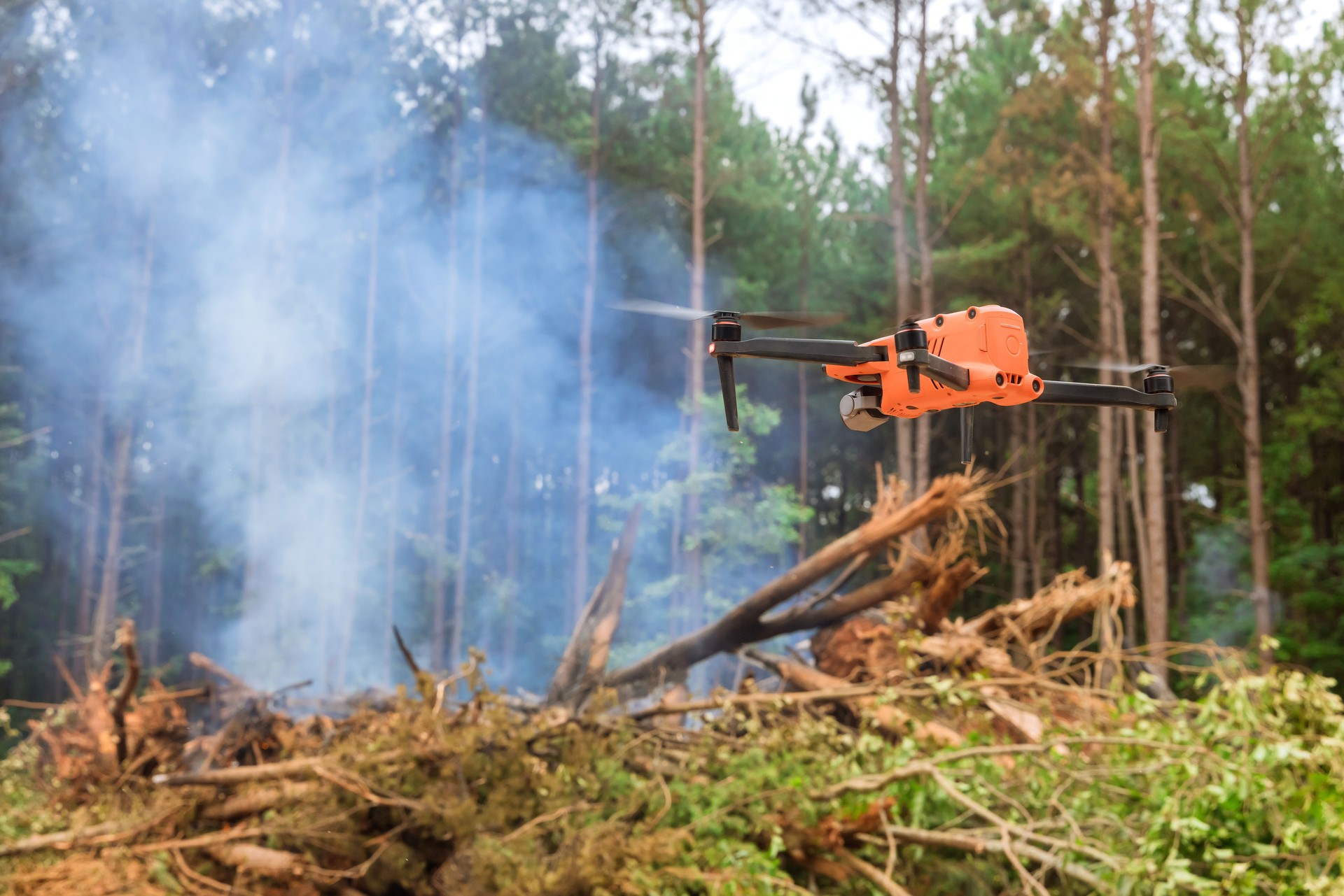 In the forest, fire services are using a drone to follow the fire into the trees